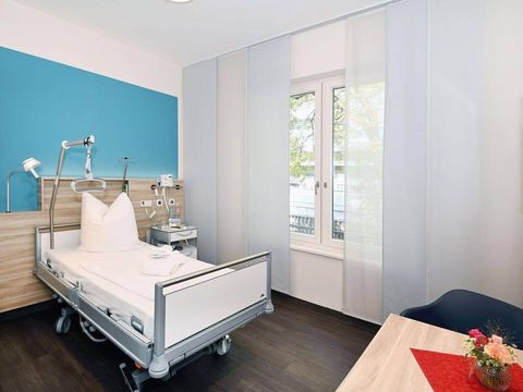 Einzelzimmer im Krankenhaus mit hellblauer Wand