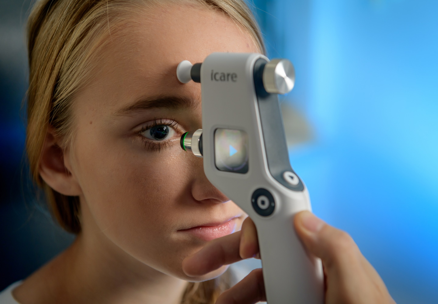 mithilfe eines Geräts wird der Innendruck des Auges bei einem jungen Mädchen gemessen